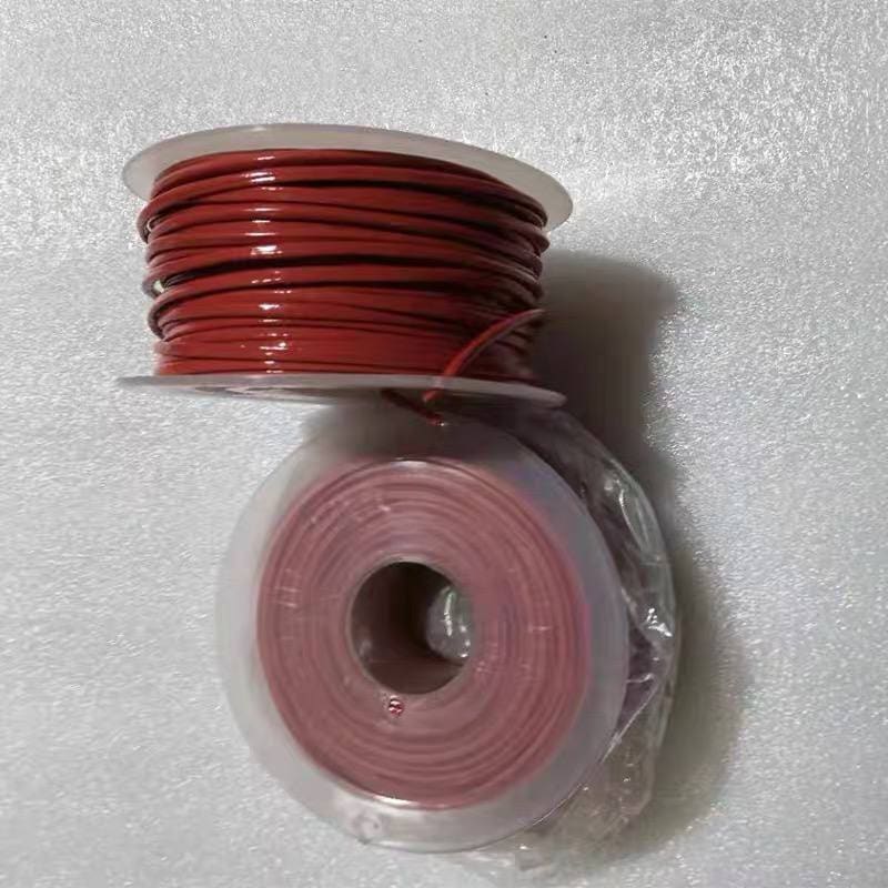 Red TS thermosensitive cable wound on a clear plastic flanged spool, with a second poly-bagged coil shown below — Aetherm TS series sample reels