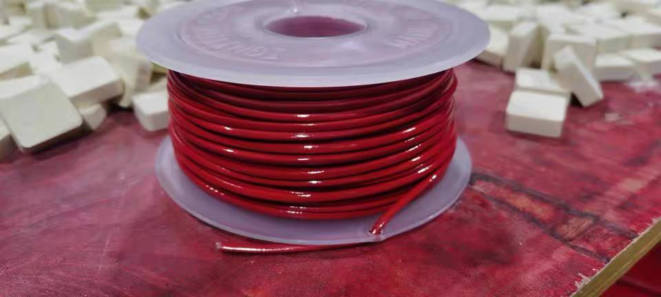 Close-up of TS cable on transparent spool showing compact diameter